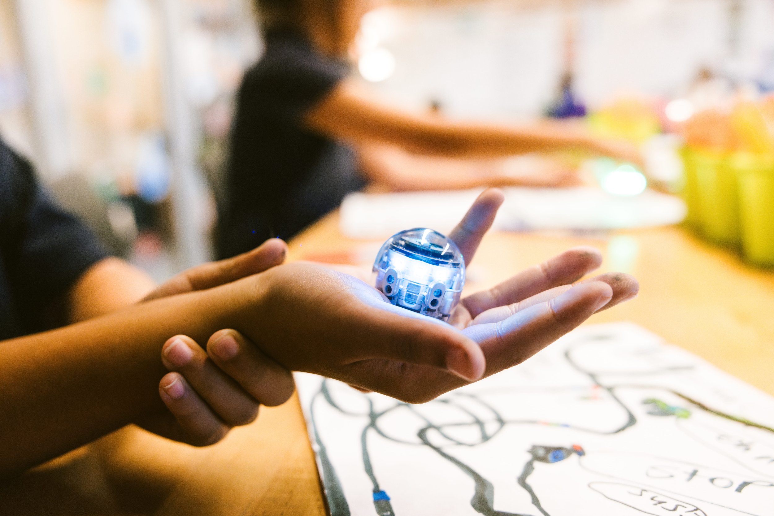 a hand holding a robot