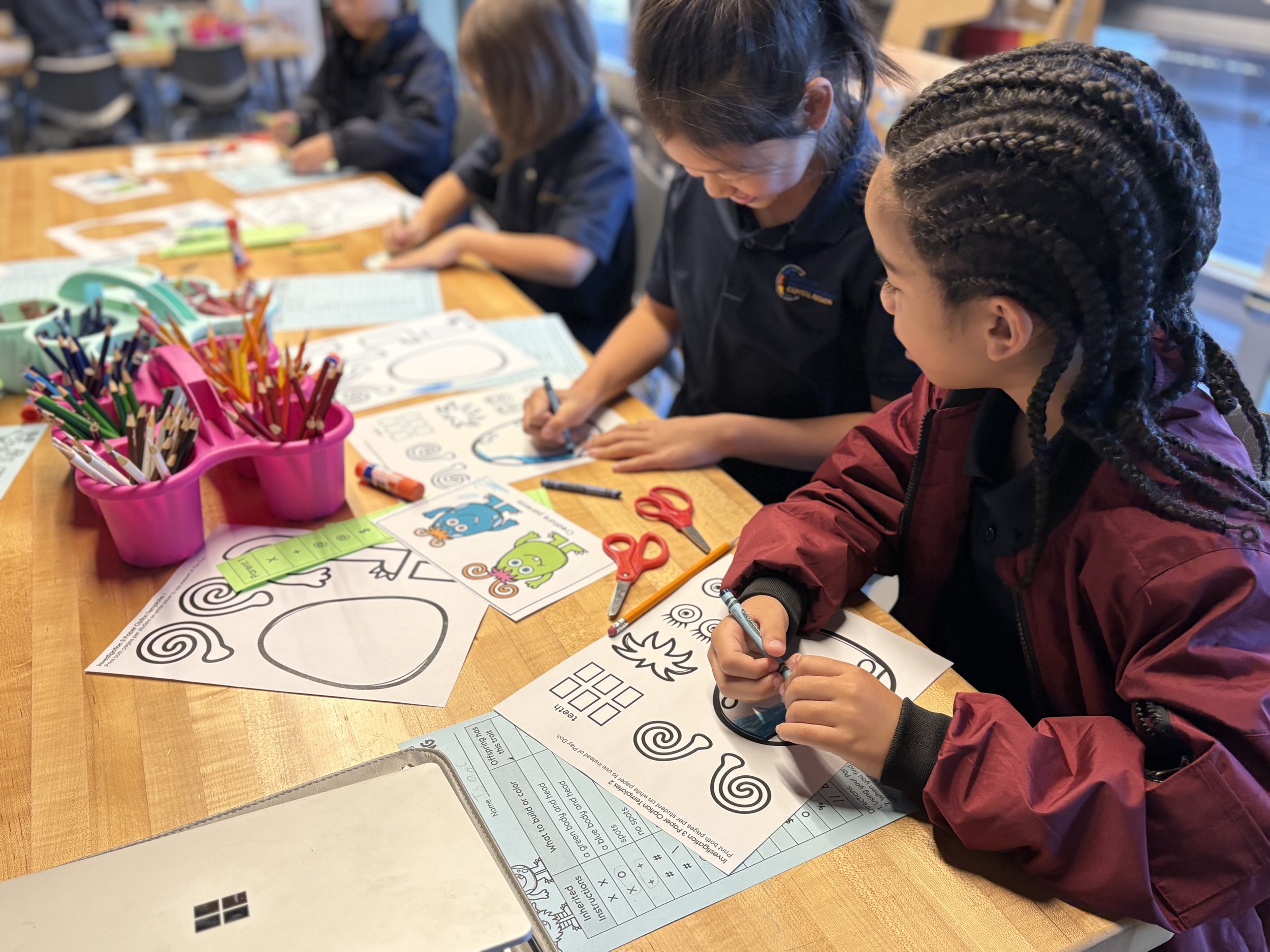 Elementary students focused on drawing and painting projects, showcasing CIS's STEAM arts education specialty