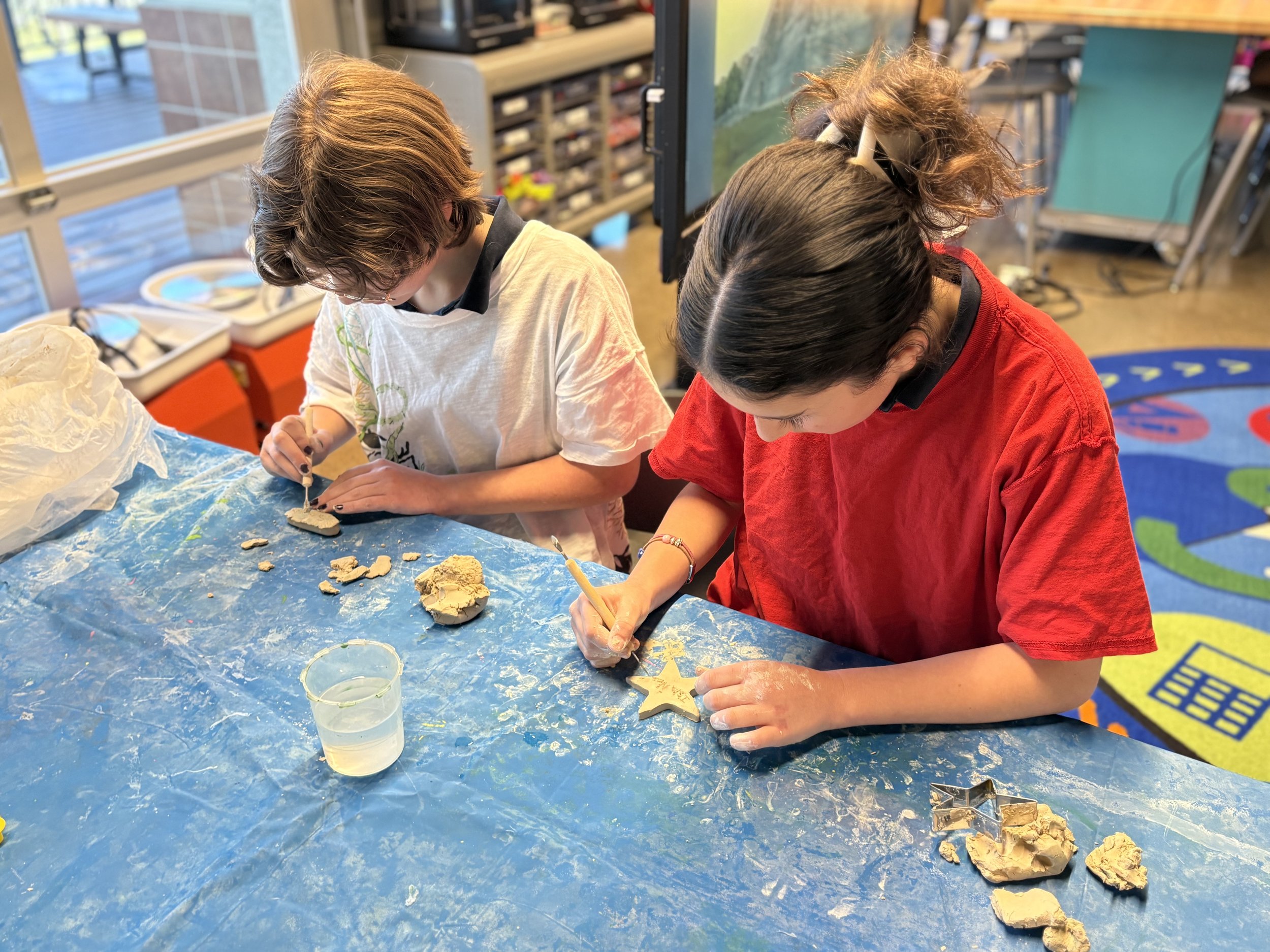 Children working together on hands-on craft activities, demonstrating CIS's engaging after-school learning programs
